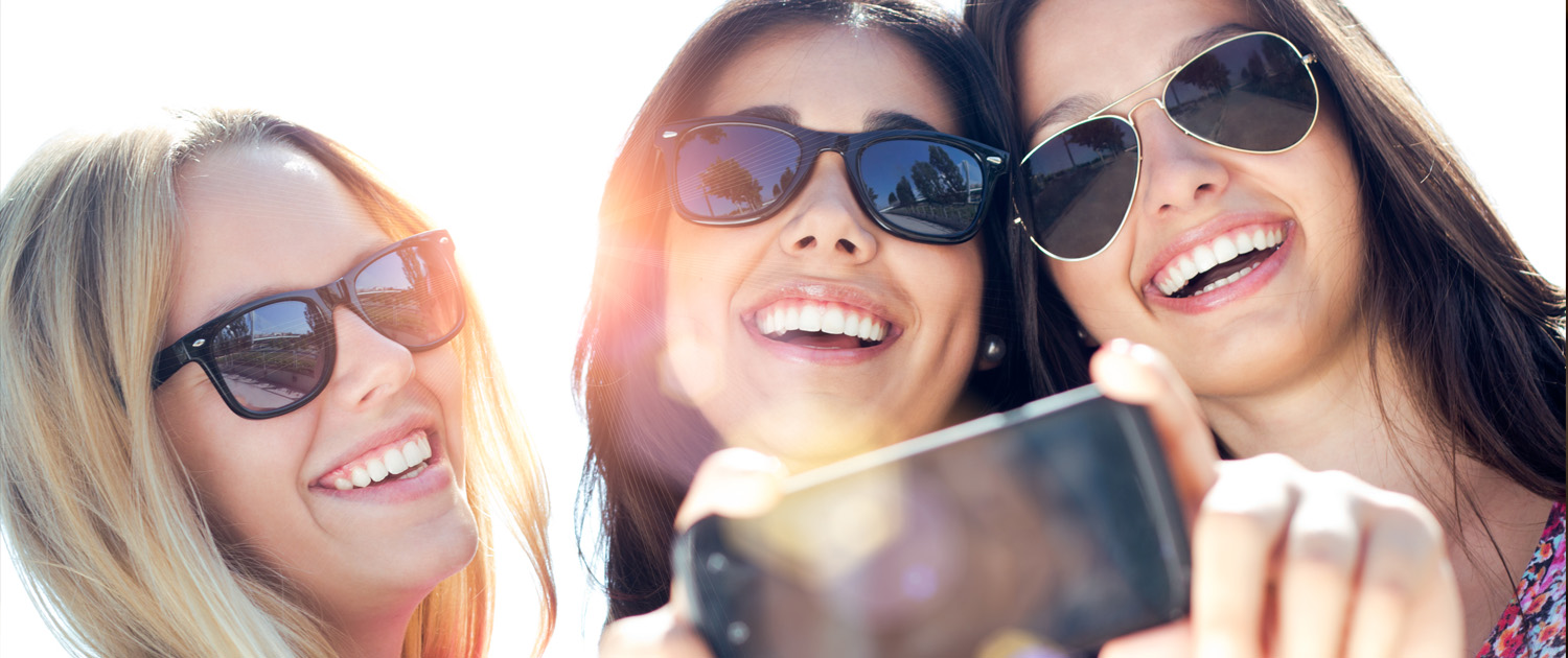 Three friends smiling for a selfie
