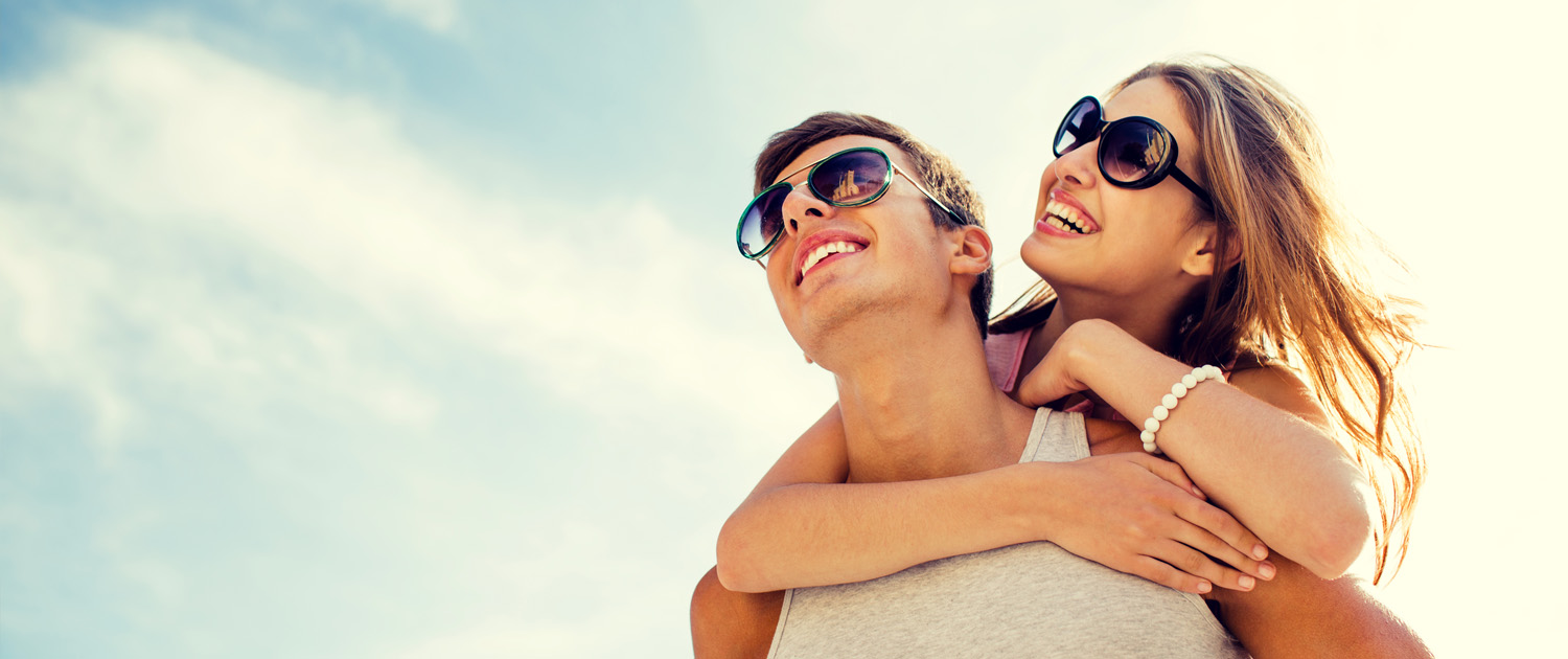 Smiling couple wearing sunglasses